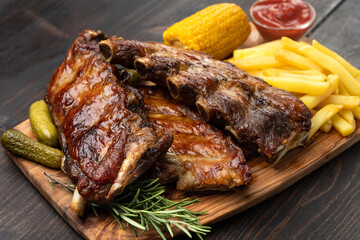 Grilled pork ribs with barbecue sauce and ketchup corn  and French fries potatoes