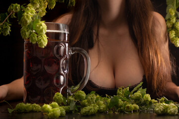 beer with female breast on wooden background in Oktoberfest style