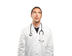 Fototapeta premium Astonished doctor looking against white background