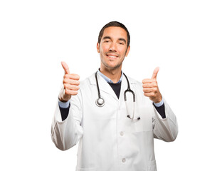 Fototapeta na wymiar Satisfied doctor with an okay gesture against white background