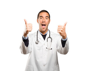 Satisfied doctor with an okay gesture against white background