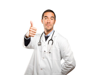 Satisfied doctor with an okay gesture against white background