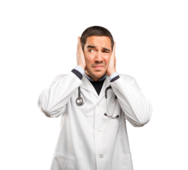 Concerned doctor covering his ears against white background
