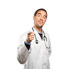 Confident doctor pointing you against white background