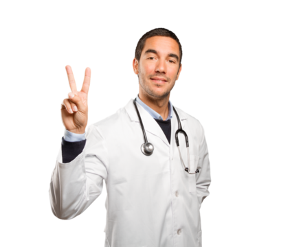 Happy doctor with a victory gesture against white background