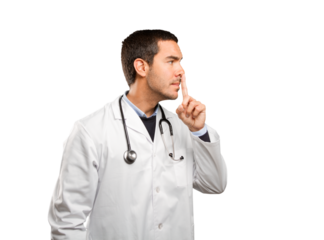Serious doctor with silence gesture against white background