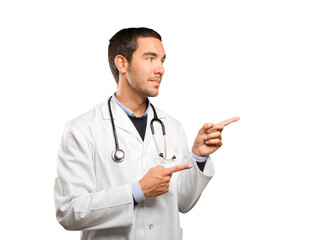 Happy doctor pointing against white background