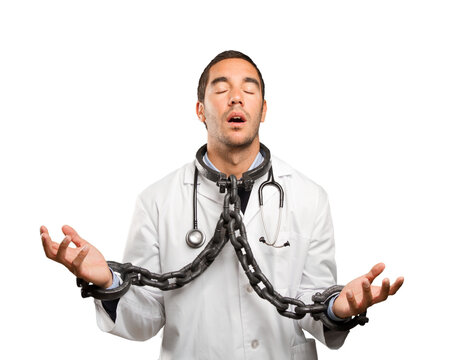 Concerned Doctor With Chains Against White Background