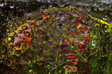 Striped spheres are located against the multicolored background with yellow-green web silhouette. Space abstraction. 3D render. 