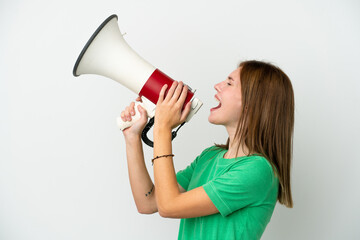 Young English woman isolated on white background shouting through a megaphone to announce something in lateral position