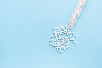 Homeopathic pills and a glass bottle on a blue background. Homeopathic medicine	