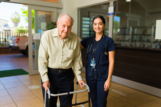 Retired older man with an hispanic nurse at the retirement home