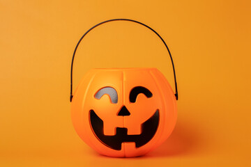 Halloween candy bowl on orange background