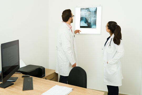Professional doctors looking at the ct scans of a patient at the office