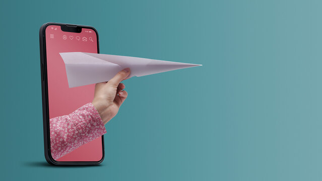 Hand holding a paper plane in a smartphone