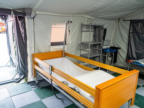 Bed For Bedridden Patients. Medical Technologies. Medical Bed In Field Hospital. Wooden Bed With Remote Control For Adjustment. Temporary Hospital Inside Tent. Medical Equipment For Bedridden Patients