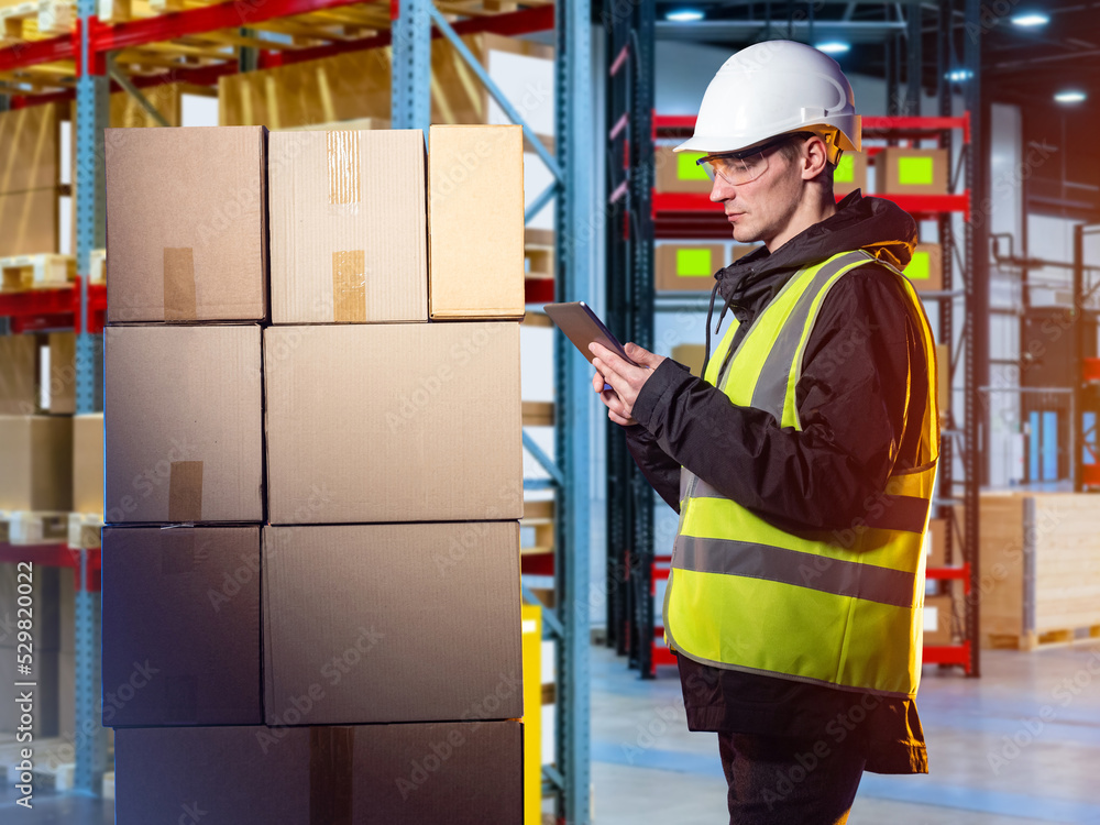 Poster warehouse manager. man with tablet in front of boxes. guy in warehouse worker uniform. career in fie