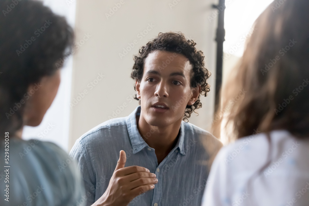 Wall mural serious motivated business team employee talking to coworkers on meeting, sharing idea, offering sol