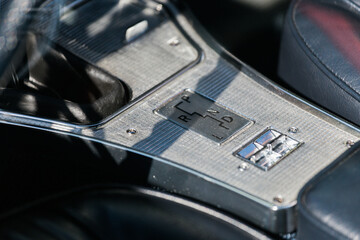 Close up of automatic transmission inside vintage vehicle. Detail of classic car interior. Old...