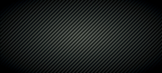 Obraz premium Vector carbon fiber texture. Dark background with lighting.