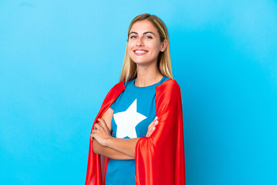 Blonde woman over isolated background in superhero costume with arms crossed