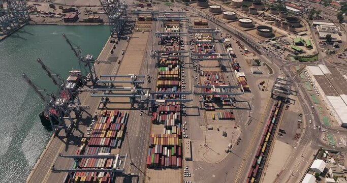 Port dock with Shipping Containers, transtainer cranes, new cars and Container ship. 

