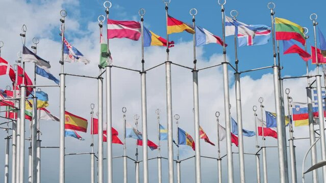 European flags on flagpoles waving with the wind. 4k footage UHD 3840x2160 in slow motion