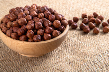View of a bowl full of hazelnuts on burlap sack
