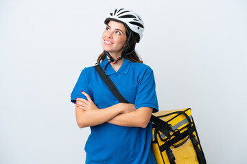 Young delivery woman with thermal backpack isolated on white background looking up while smiling