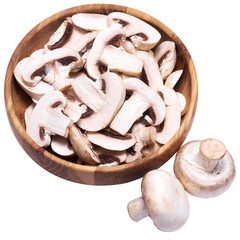 Sliced white champignon mushrooms in wooden bowl isolated