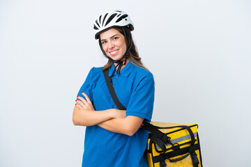 Young delivery woman with thermal backpack isolated on white background with arms crossed and looking forward