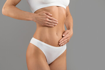 Cropped Of Young Female In White Underwear Touching Belly With Two Hands
