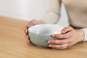 Cropped of woman holding empty plate, starving