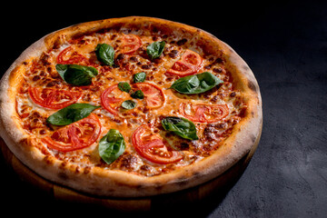 Delicious fragrant pizza with mozzarella, tomatoes and basil with tomato sauce - Margherita