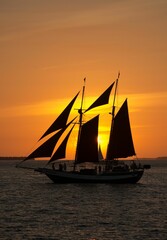 Vertical shot of a pirate-like ship sailing on water at sunset near Key West, Florida