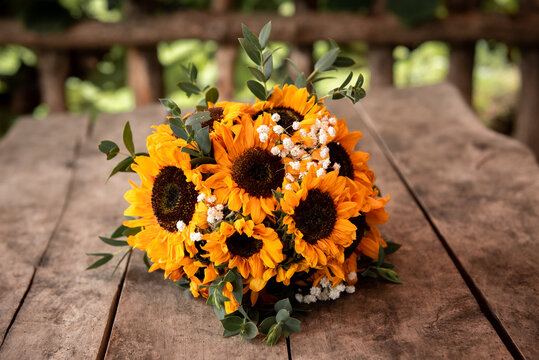 Bouquet of sunflowers on a wooden table. Summer background 