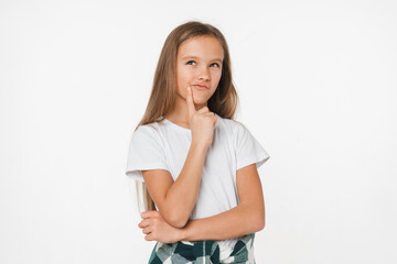 Smart small young pensive caucasian schoolgirl daughter girl in white t-shirt thinking looking dreaming looking upwards isolated in white background