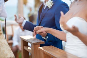 Obraz na płótnie Canvas bride and groom holding hands at wedding ceremony 