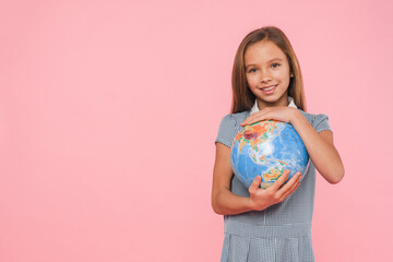 Happy caucasian young schoolgirl preteen girl holding hugging Earth globe for geography lessons,...