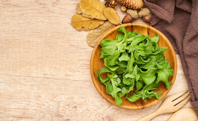 top view or flat lay crystalline ice plant or crystal ice plant in wood plate on wooden background. green leaves Crystalline ice plant vegetable food in wood plate on wooden background