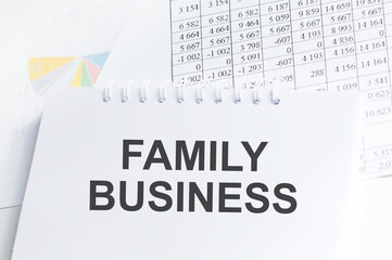Family Business. Family business written in a white notepad. Business concept.