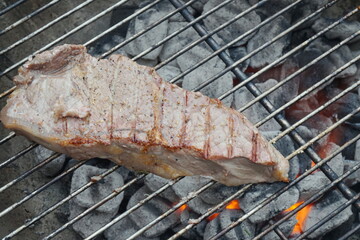 Single Bonelss Porterhouse Steak over Glowing Coals of a Kettle Grill