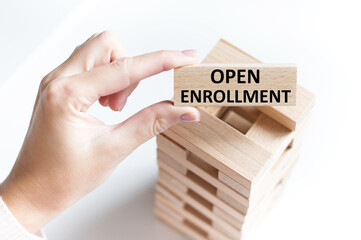 Two wooden cubes with the words Open Enrollment. Medical concept