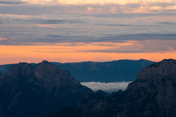 Naklejka na ściany i meble sunrise over the mountains in fog