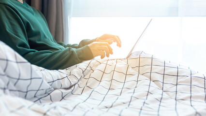 Man working on the bed had white sheets in the morning.