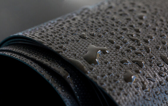 Water droplets on the rubber membrane. Waterproofing...  Close-up selective focus area.