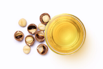 Macadamia nut and macadamia oil in glass bowl isolated on white background. Top view. Flat lay.  - obrazy, fototapety, plakaty