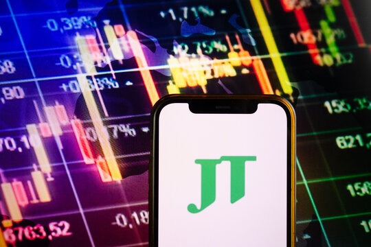 KONSKIE, POLAND - September 10, 2022: Smartphone displaying logo of Japan Tobacco company on stock exchange chart background