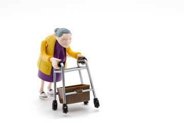 Grandmother with walker, toys, white background, cropped image