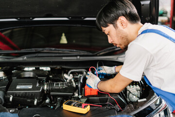 Asian Auto mechanic is diagnosing the problem with engine to repair at the shop, Car Service Center and Automobile Maintenance